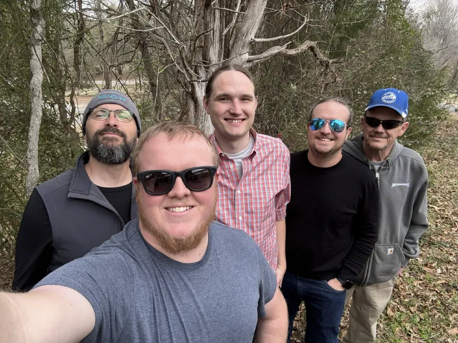 Five friends from the wireless ISP industry visiting me in Centreville, Alabama, smiling outdoors in front of bare winter trees.